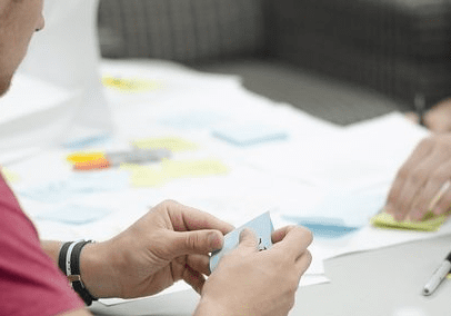 Team brainstorming with sticky notes.