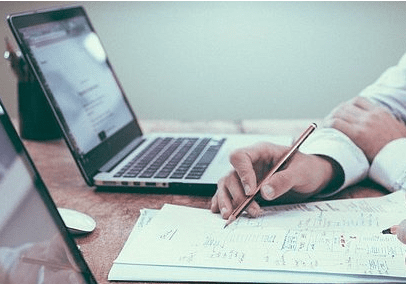 Teamwork, reviewing documents, laptops.