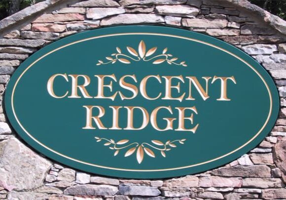 Crescent Ridge sign on stone wall.